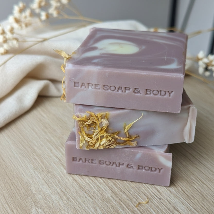 Three soap bars stacked on top of each other with 'Bare Soap & Body' branding stamped on the side