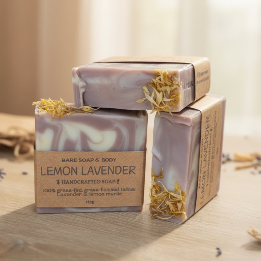 Three decorative purple lavender soap bars on a wooden surface