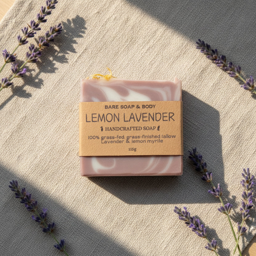 Purple bar of soap with a brown label on a linen surface