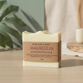 Bar of soap with a brown label on a wooden surface