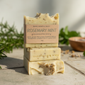 Three bars of Bare Soap & Body Rosemary Mint soap stacked on top of each other
