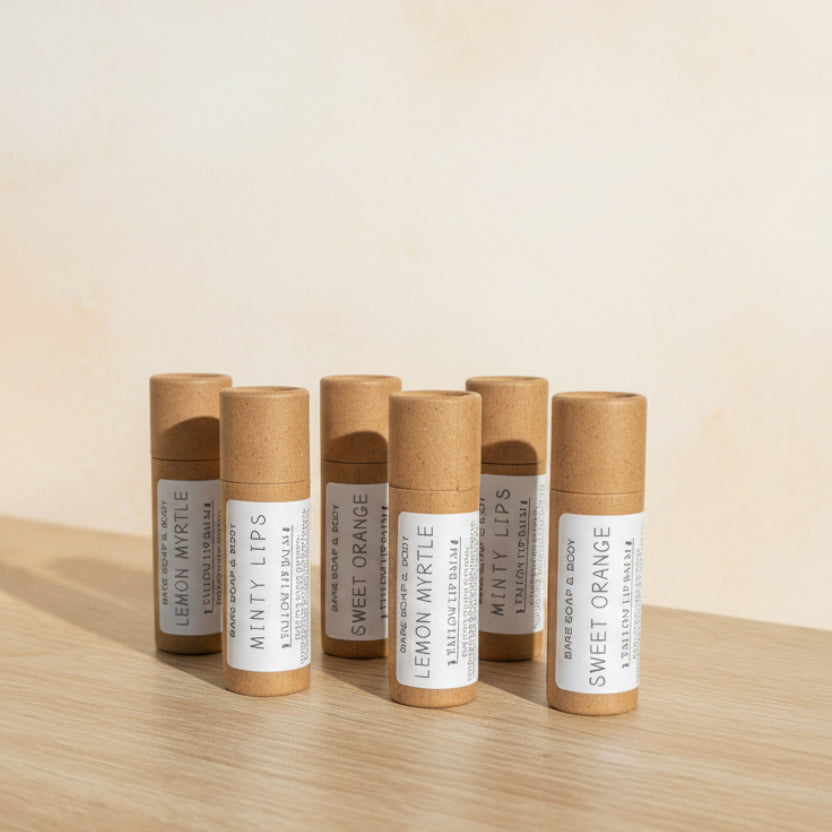 Set of lip balms in eco-friendly kraft tube packaging on a wooden surfaceube 