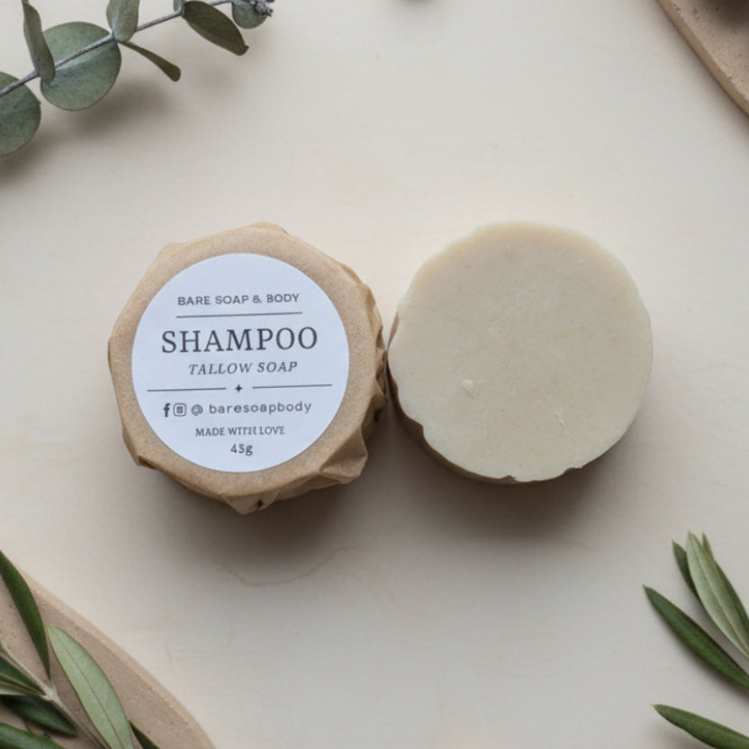 Bar of shampoo soap with a label on a wooden surface