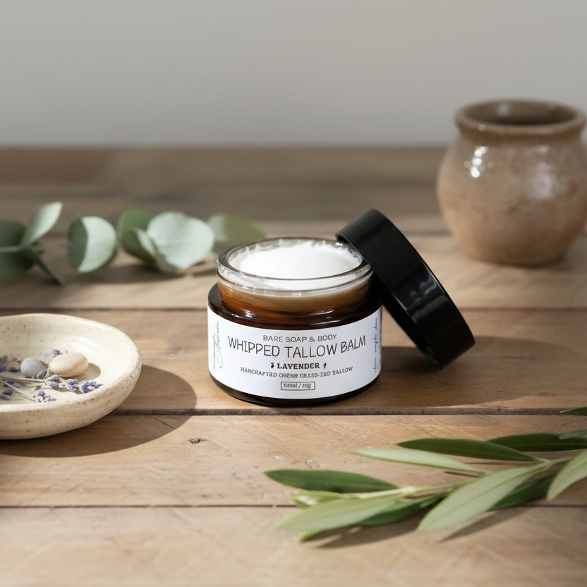 Whipped tallow balm jar with a black lid on a wooden surface
