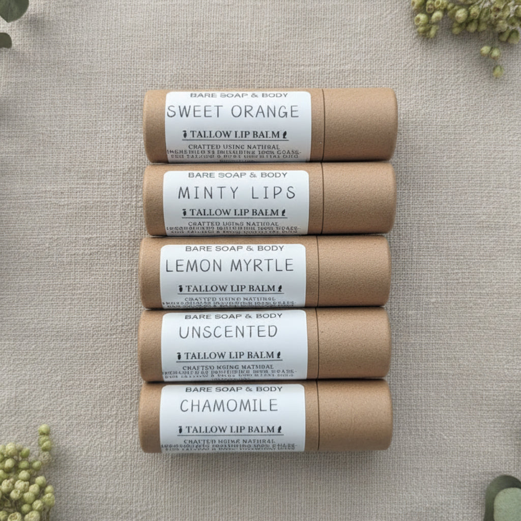 Four rolled lip balm tubes stacked vertically on a gray wood-textured background. The labels read Chamomile, Unscented, Lemon Myrtle, and Minty Lips.